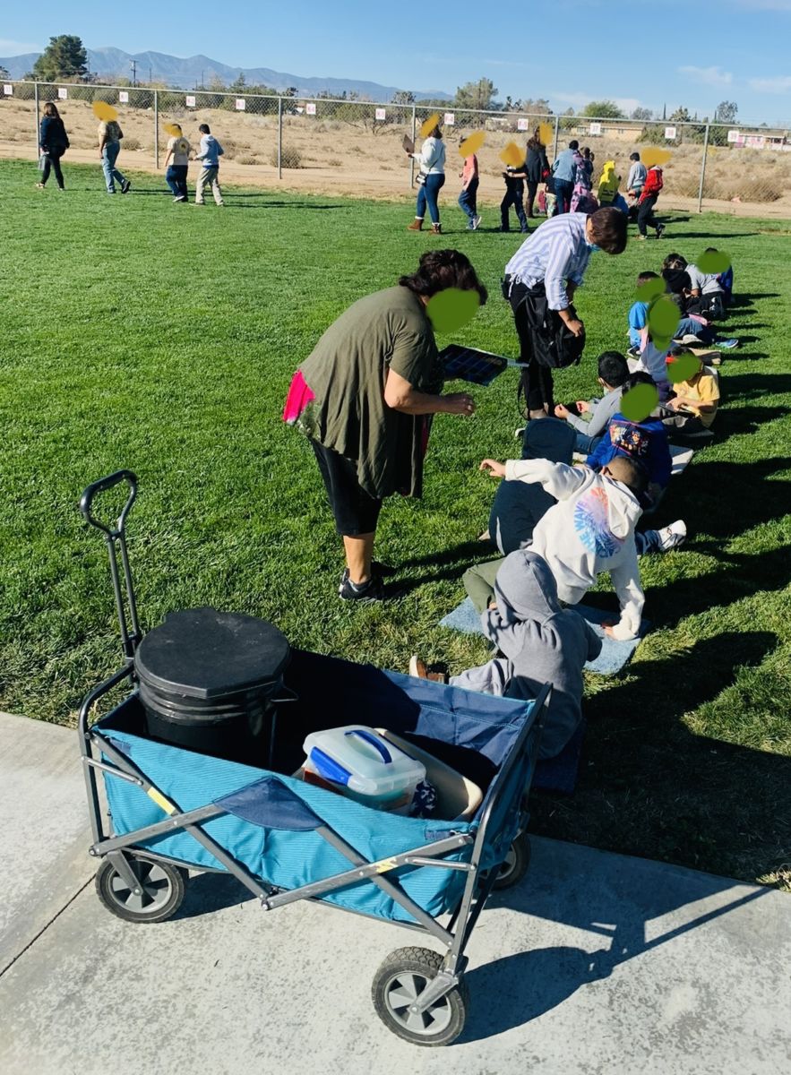 This is a photo of my students sitting on their carpet samples outside during an emergency drill.